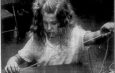 June 13, 1991: Samantha Sherlock strings beads onto strings as she creates a belt. She is participating in Camp Fire Day Camp in Alliance’s Central Park this week.